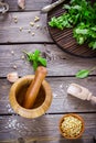 Ingredients for pesto and wooden mortar on the table. Royalty Free Stock Photo