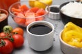 Ingredients for poke bowl on grey table, closeup