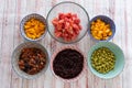 Ingredients for a poke in a bowl. Tomatoes, black rice, tuna or salmon, mango and soybeans