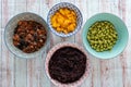 Ingredients for a poke in a bowl. Tomatoes, black rice, tuna or salmon, mango and soybeans