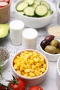 Ingredients for poke bowl on white marble table