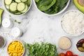 Ingredients for poke bowl on white marble table, flat lay. Space for text