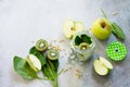 Ingredients for the preparation of green smoothies - apple, kiwi, spinach, pine nuts. Healthy vegan food concept.