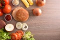 Ingredients for preparation of a homemade burger on kitchen bench Royalty Free Stock Photo