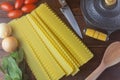 Ingredients preparation raw lasagna dough on rustic wooden table Royalty Free Stock Photo