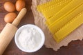 Ingredients preparation raw lasagna dough on rustic wooden table Royalty Free Stock Photo