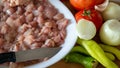 Ingredients prepared for chicken dinner. chopped chicken meat, tomatoes, peppers, onions and garlic