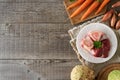 Ingredients for preparing beef bone broth or soup - marrow bones and vegetables on wooden background Royalty Free Stock Photo