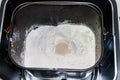 Ingredients for preparing bread in bread pan of electric bread maker Royalty Free Stock Photo