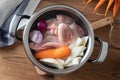 Ingredients for preparing chicken bone broth in a pot