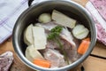Ingredients for preparing chicken bone broth in a pot