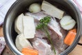 Ingredients for preparing chicken bone broth in a pot