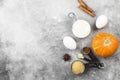 Ingredients for pumpkin pie - flour, pumpkins, eggs, cane sugar, various spices (nutmeg, ginger, cinnamon, anise) on a gray Royalty Free Stock Photo