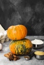 Ingredients for pumpkin pie - flour, pumpkins, eggs, cane sugar, various spices (nutmeg, ginger, cinnamon, anise) on a gray Royalty Free Stock Photo