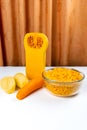 Ingredients for pumpkin soup. Diced pumpkin, carrots, potatoes and half a peeled pumpkin on on white table on orange fabric Royalty Free Stock Photo