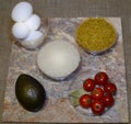 Quick cooking ingredients of delicious oriental dishes: eggs, bulgur, rice, avocado, cherry tomatoes, bay leaf Royalty Free Stock Photo