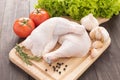 Ingredients and raw chicken leg on cutting board on wood table Royalty Free Stock Photo