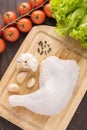 Ingredients and raw chicken leg on cutting board on wood table Royalty Free Stock Photo