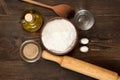 Ingredients for recipe pizza dough on dark wooden background.