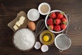 Ingredients for recipe of strawberry cake or pie on dark wooden background. Royalty Free Stock Photo
