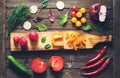 Ingredients for salad around cutting board. Fresh vegetables and herbs. Cooking Royalty Free Stock Photo