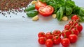 Ingredients for salad: raw cherry tomatoes, basil, garlic, pepper on the gray table with copy space. Cooking concept. Italian food Royalty Free Stock Photo