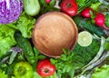 Ingredients for salad and a wooden empty bowl