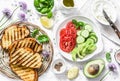 Ingredients for sandwiches - cream cheese, grilled bread, avocado, tomatoes, cucumbers, chives on a light background, top view. Su