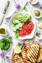 Ingredients for sandwiches - cream cheese, grilled bread, avocado, tomatoes, cucumbers, chives on a light background, top view. Su