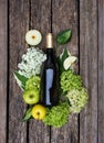 Ingredients for sangria. Bottle of wine, apples, hydrangea on wooden table. Apple cider Royalty Free Stock Photo