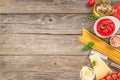 ingredients for Spaghetti pasta fresh cherry tomatoes, garlic, basil leaves, parmesan, olive oil on a wooden background Royalty Free Stock Photo