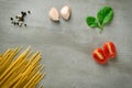 Ingredients spaghetti tomatoes on stone background Royalty Free Stock Photo
