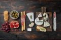 Ingredients for spanish food, meat cheede, herbs, on dark wooden background, flat lay Royalty Free Stock Photo