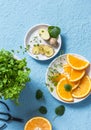 Ingredients for summer cold drink - orange slices, ginger, mint. Lemonade ingredients on blue background