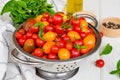 Ingredients for summer vegetable salad with cherry tomatoes, basil herb, olive oil and salt on a white wooden background. Royalty Free Stock Photo