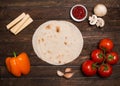 Ingredients for tacos or burrito making with copyspace. Ingredients for cooking on wooden rustic background top view place for te