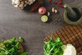 Ingredients of thai food, lime, chili, garlic and vegetables, top view on wooden table.