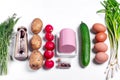 Ingredients to make Okroshka cold soup. Sausage, radish, potato, cucumber, eggs, kvass, herbs and spices Royalty Free Stock Photo