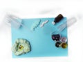 Ingredients to making slime at home, homemade DIY handgum or slime toy on blue surface. Flat lay, top view
