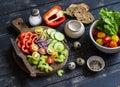 Ingredients to prepare vegetable salad - tomatoes, cucumber, celery, bell pepper, red onion, quail eggs, garden herbs and spices o Royalty Free Stock Photo