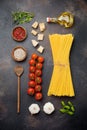 Ingredients for traditional Italian pasta dish. Uncooked raw spaghetti, parmesan cheese, olive oil, garlic, basil leaves, pepper, Royalty Free Stock Photo