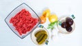 Ingredients for a traditional Swedish dish beef Lindstrom. Freshly minced beef, boiled potato, white chopped onion, pickles, pickl Royalty Free Stock Photo