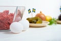 Ingredients for a traditional Swedish dish beef Lindstrom. Freshly minced beef, boiled potato, white chopped onion, pickles, pickl Royalty Free Stock Photo