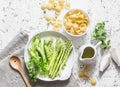 Ingredients for vegetarian lunch - orecchiette pasta, green peas, asparagus, cream on a light background