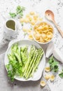 Ingredients for vegetarian lunch - orecchiette pasta, green peas, asparagus, cream on a light background