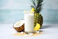 ingredients of virgin pina colada pineapple, coconut milk styled around a glass