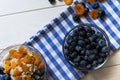 Ingredients for a wholesome healthy breakfast. Fresh blueberries, dried apricots and oatmeal. Top view