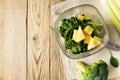 Ingrediets for green smoothie - parsley, spinach, broccoli and celery on wooden table