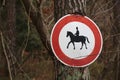 Ingrown traffic sign prohibiting thoroughfare of equestrians