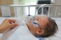 Inhalation baby boy age about 1 years old on patient bed. Respiratory Syncytial Virus RSV. Intensive care on bed at hospital